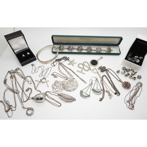 A silver Eric Smith bracelet A silver Gucci heart bracelet, full hallmarks and Gucci marks verso, three Thomas Sabo silver pendants, Pandora beads, a silver starburst pendant set with pink gems etc
