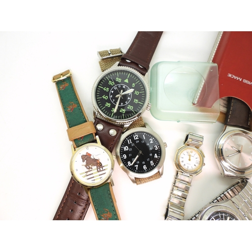 896 - A Swatch Irony in original box, a further Swatch watch with a black dial and further fashion watches... 