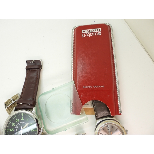 896 - A Swatch Irony in original box, a further Swatch watch with a black dial and further fashion watches... 