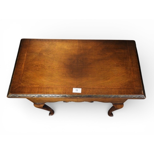 11 - A small 20th century mahogany crossband veneered fold over card table with fret cut friezes on cabri... 