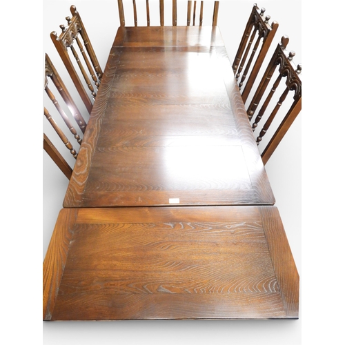 14 - A 20th century elm dining suite consisting pull out extending dining table on trestle supports, 74cm... 