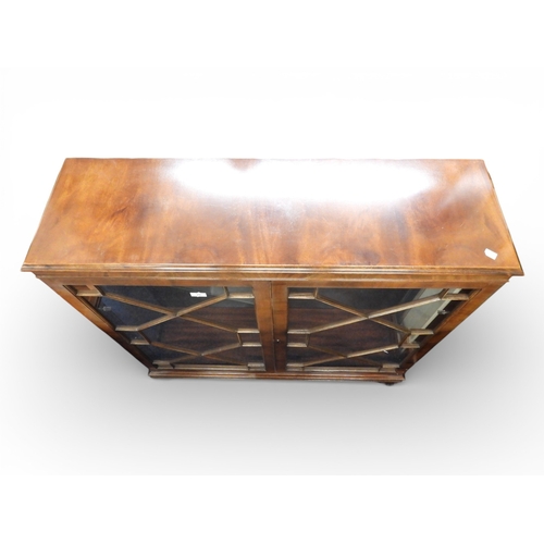 29 - An early 20th century mahogany astragal glazed two door display cabinet on bracket feet, 112cm high ... 