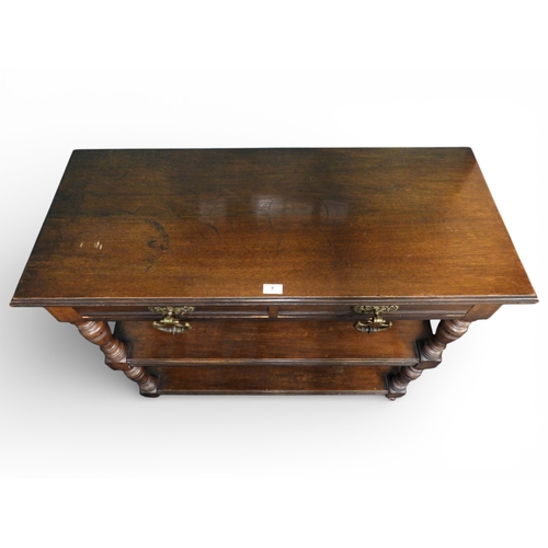 7 - An early 20th century oak three tier buffet with rectangular top with pair of frieze drawers over tw... 