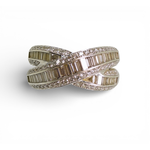 A 18ct white gold Mappin & Webb diamond crossover ring, set with baguettes and brilliant cut diamonds, with an estimated approx diamond content of 1ct, finger size K, weight 7.3gms