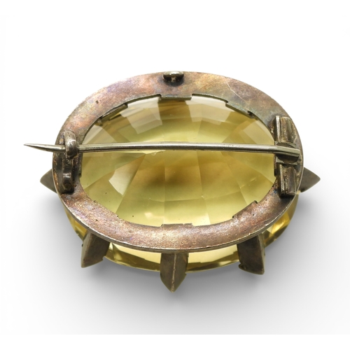 743 - A Victorian citrine brooch with a white metal star mount, and set with a 35mm 27mm x 21mm specimen c...