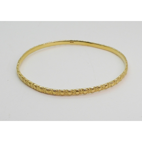 700 - A bright yellow metal bangle stamped 21C, diameter6.3cm, weight 13.8gms...