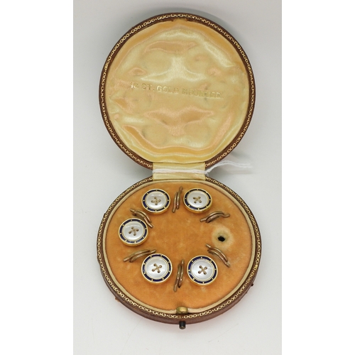 706 - A boxed set of five enamel and mother of pearl buttons (one missing) stamped 18ct to the edge, weigh...