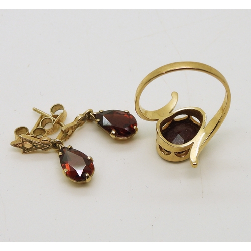 714 - A yellow metal garnet ring, size O, together with a pair of garnet drop earrings, length 2cm, weight...