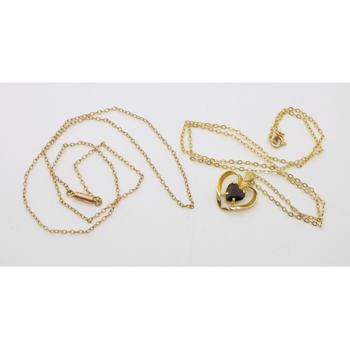 716 - A 9ct gold heart shaped garnet pendant and yellow metal chain. length of pendant 1.7cm, chain 42cm, ...