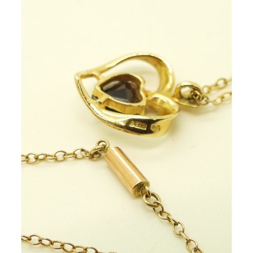 716 - A 9ct gold heart shaped garnet pendant and yellow metal chain. length of pendant 1.7cm, chain 42cm, ...