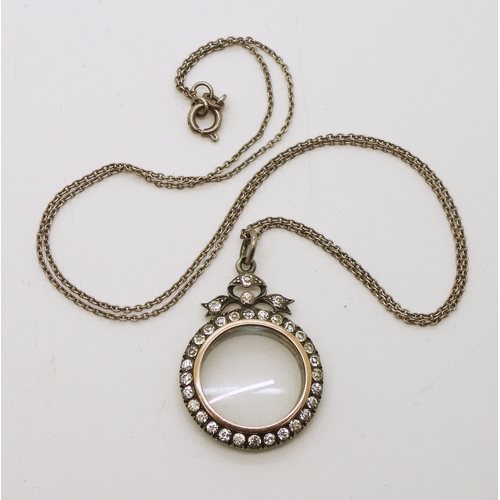 735 - A French silver and yellow metal locket set with diamante, on a 50cm silver chain...