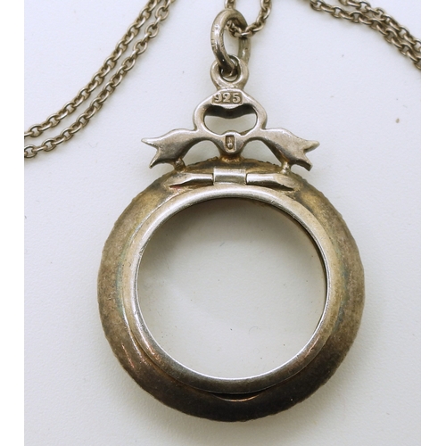 735 - A French silver and yellow metal locket set with diamante, on a 50cm silver chain...