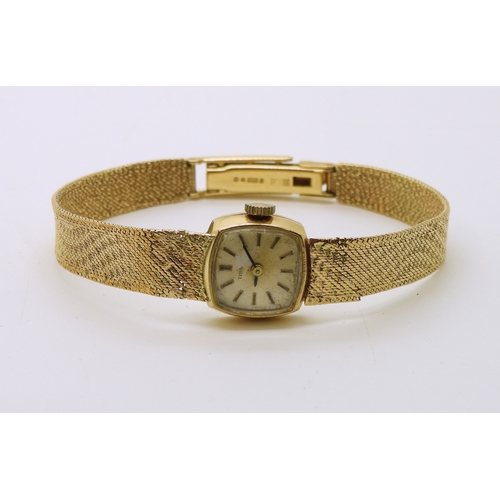 740 - A 9ct gold ladies Tissot watch with integral woven strap, length 18.5cm, weight including mechanism ...