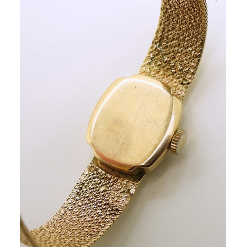 740 - A 9ct gold ladies Tissot watch with integral woven strap, length 18.5cm, weight including mechanism ...