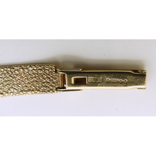 740 - A 9ct gold ladies Tissot watch with integral woven strap, length 18.5cm, weight including mechanism ...