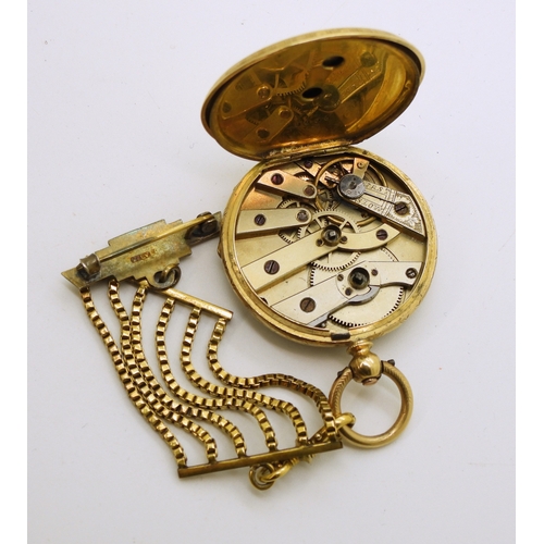 745 - An 18k gold fob watch, diameter 3.5cm, weight of watch with mechanism 34.4gms with a gold plated sil...