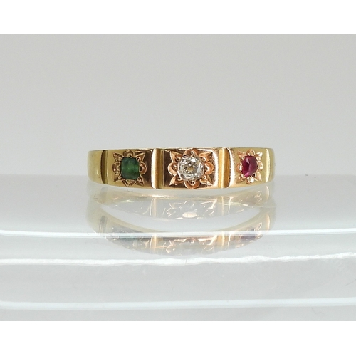 748 - A bright yellow metal ring, star set with a ruby, diamond and emerald, size N, weight 3.6gms...