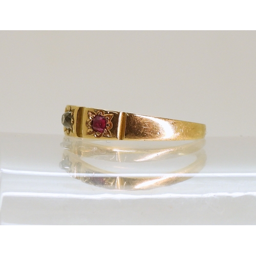 748 - A bright yellow metal ring, star set with a ruby, diamond and emerald, size N, weight 3.6gms...