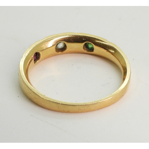 748 - A bright yellow metal ring, star set with a ruby, diamond and emerald, size N, weight 3.6gms...