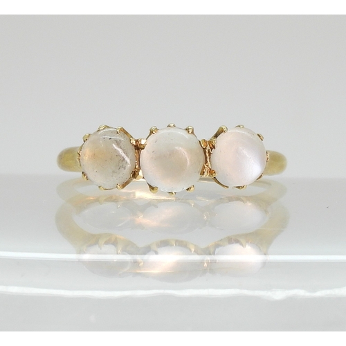 754 - An 18ct ring set with three moonstones in multi claw settings, size M1/2, weight 2.7gms...