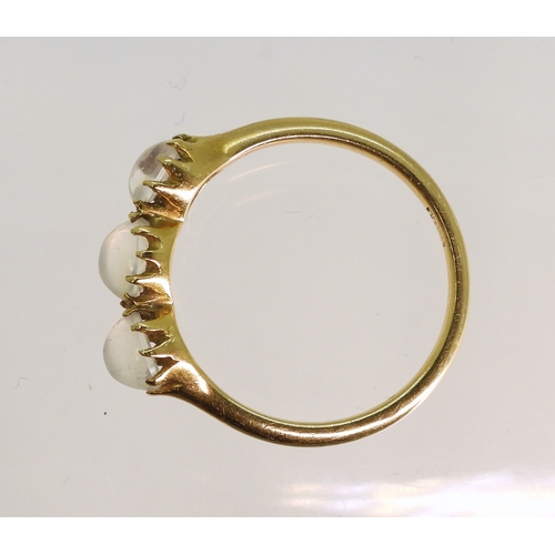 754 - An 18ct ring set with three moonstones in multi claw settings, size M1/2, weight 2.7gms...