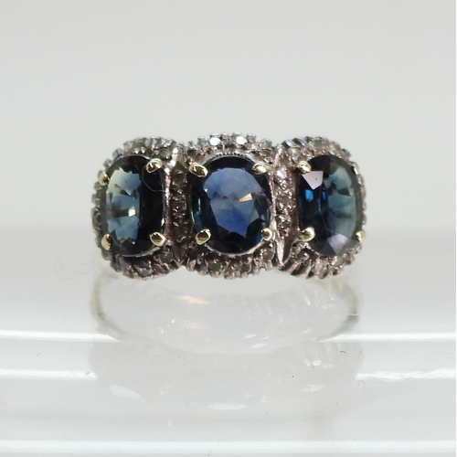 761 - A yellow and white metal ring set with three teal green oval cut sapphires of estimated approx 6.9mm... 