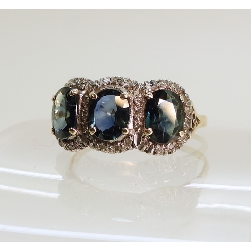 761 - A yellow and white metal ring set with three teal green oval cut sapphires of estimated approx 6.9mm... 