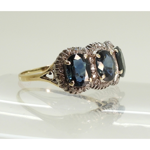 761 - A yellow and white metal ring set with three teal green oval cut sapphires of estimated approx 6.9mm... 
