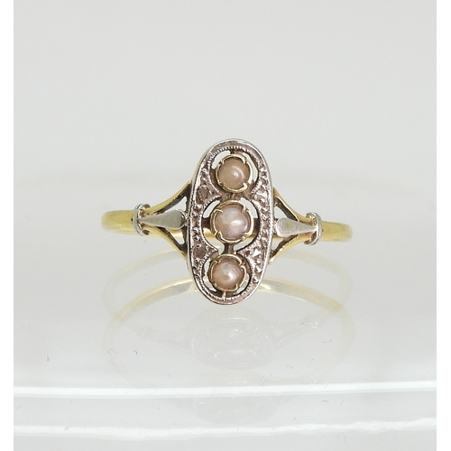 763 - A vintage pearl and diamond accent ring, made in yellow and white metal with fleur de lis shoulders,... 