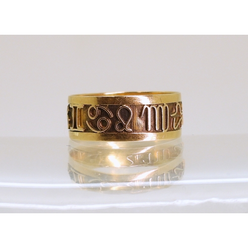766 - A bright yellow metal Zodiac ring, size k, weight 1.3gms