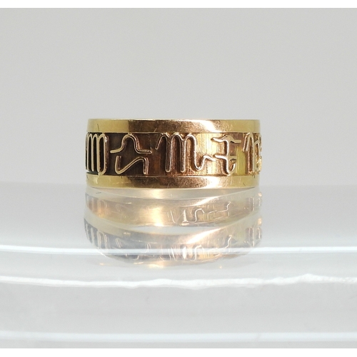766 - A bright yellow metal Zodiac ring, size k, weight 1.3gms
