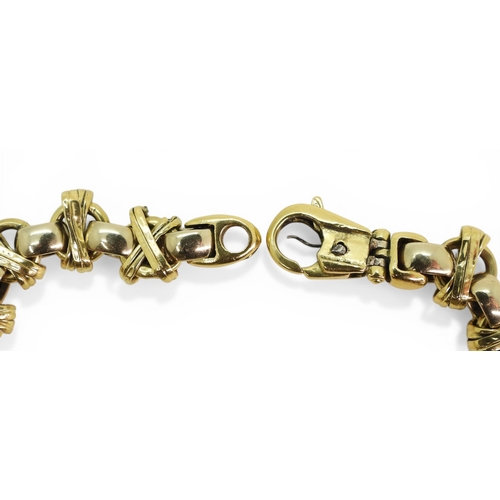 2702 - A DECORATIVE BRACELETmade in 18ct yellow and white gold, with cross over design, length 21.5cm, weig... 