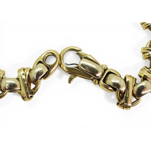 2702 - A DECORATIVE BRACELETmade in 18ct yellow and white gold, with cross over design, length 21.5cm, weig... 