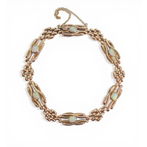 2706 - A VINTAGE OPAL BRACELETmade in 9ct rose gold, the knot shaped links set with oval opals of approx 4.... 