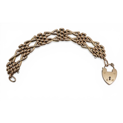2710 - A GATE BRACELETmade in 9c rose gold with unusual crossed links, and heart shaped clasp. Length 18cm,... 