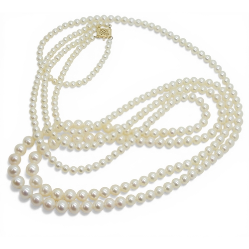 2719 - A DOUBLE OPERA LENGTH OF PEARLSthe substantial tapered strings of pearls are white in colour with go... 
