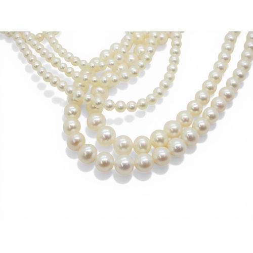 2719 - A DOUBLE OPERA LENGTH OF PEARLSthe substantial tapered strings of pearls are white in colour with go... 