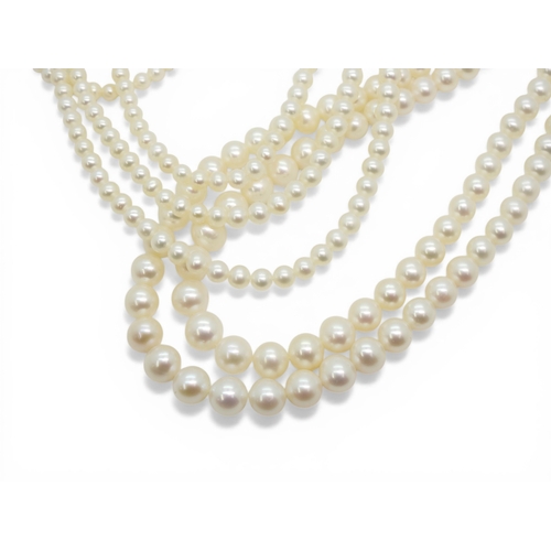 2719 - A DOUBLE OPERA LENGTH OF PEARLSthe substantial tapered strings of pearls are white in colour with go... 