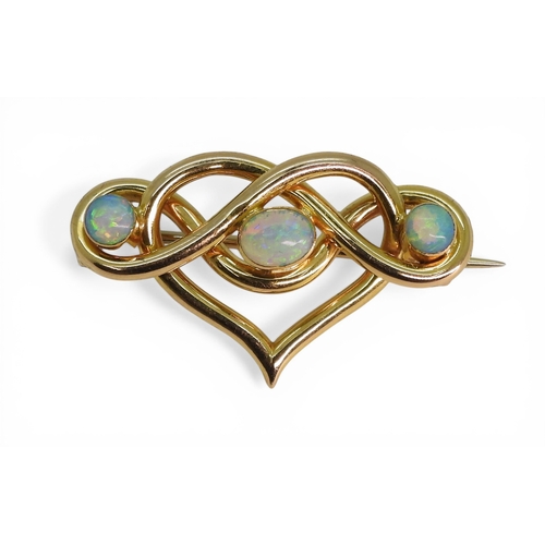 2726 - AN OPAL BROOCHmade in 15ct gold with a heart shaped lover's knot design, set with three fiery opals.... 