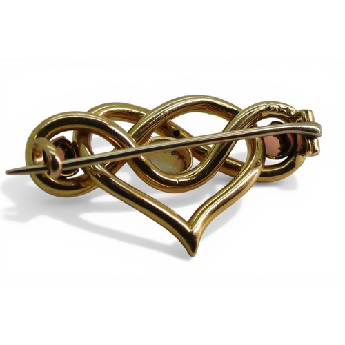 2726 - AN OPAL BROOCHmade in 15ct gold with a heart shaped lover's knot design, set with three fiery opals.... 