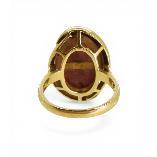 2728 - AN ITALIAN CORAL RINGmade in 18ct gold, and set with an oval red coral of 16mm x 12mm. Finger size M... 