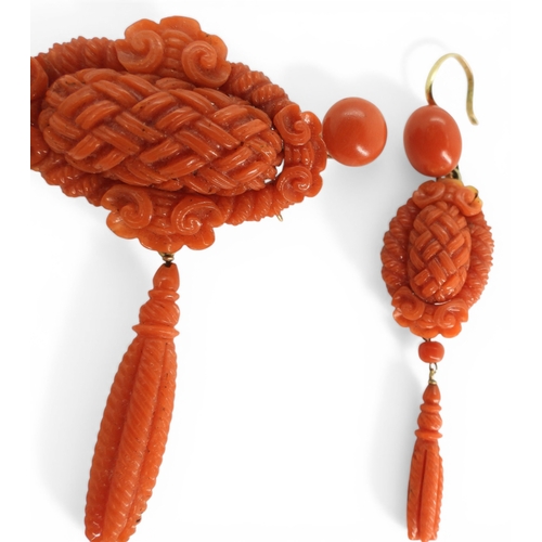 2731 - A VICTORIAN CORAL SUITEcomprising of a brooch and earrings, both carved with intricate knotwork, she... 