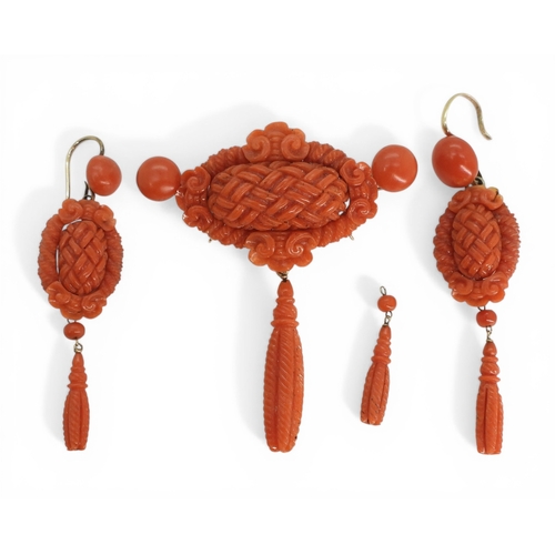 2731 - A VICTORIAN CORAL SUITEcomprising of a brooch and earrings, both carved with intricate knotwork, she... 
