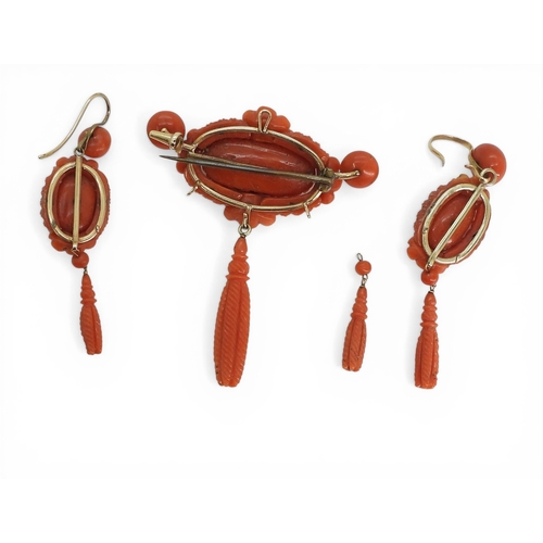 2731 - A VICTORIAN CORAL SUITEcomprising of a brooch and earrings, both carved with intricate knotwork, she... 