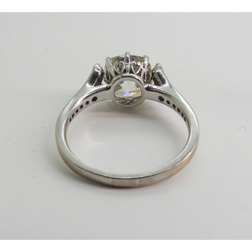 2734 - A SUBSTANTIAL CUSHION CUT DIAMOND RINGre-set in a modern white metal mount, with pave set diamond sh... 