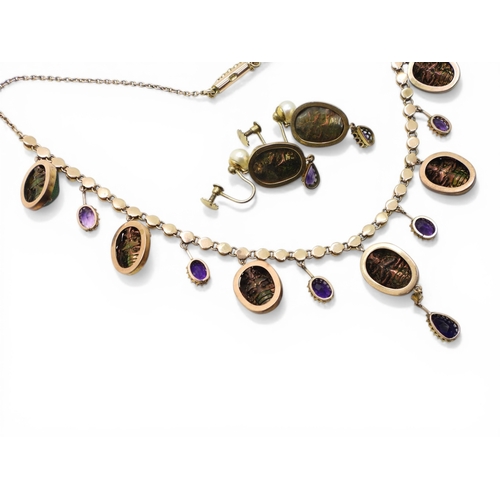 2736 - A JEWEL SCARAB BEETLE NECKLACEmounted in 9ct gold, the seven iridescent beetles are suspended from a... 