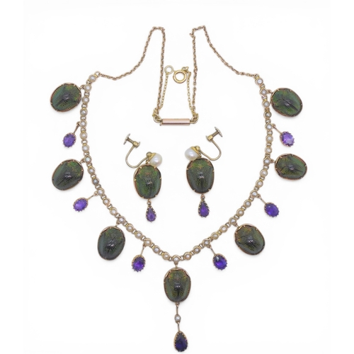 2736 - A JEWEL SCARAB BEETLE NECKLACEmounted in 9ct gold, the seven iridescent beetles are suspended from a... 