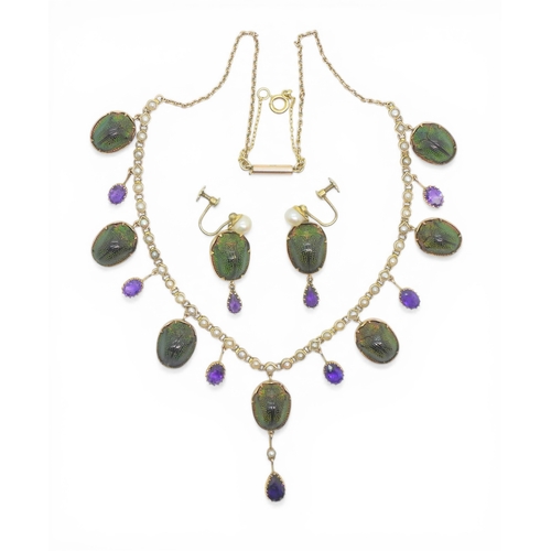 2736 - A JEWEL SCARAB BEETLE NECKLACEmounted in 9ct gold, the seven iridescent beetles are suspended from a... 