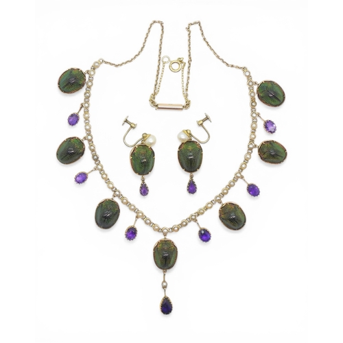 2736 - A JEWEL SCARAB BEETLE NECKLACEmounted in 9ct gold, the seven iridescent beetles are suspended from a... 