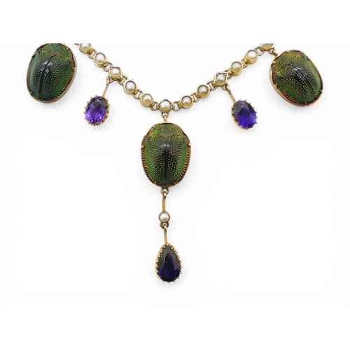 2736 - A JEWEL SCARAB BEETLE NECKLACEmounted in 9ct gold, the seven iridescent beetles are suspended from a... 